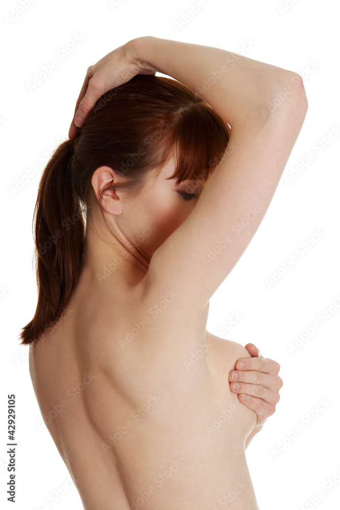 Young beautiful woman is standing and touching her breast. Young beautiful woman is standing and touching her breast.