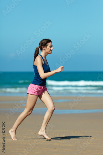 Girl running on the beach in barefoot