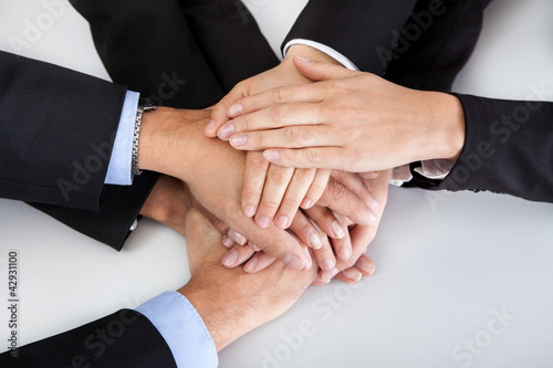 Business colleagues with hands stacked together