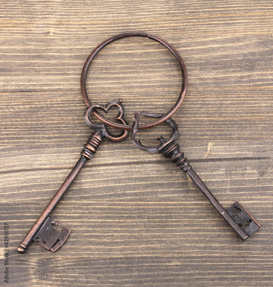 a bunch of antique keys on wooden background a bunch of antique keys on wooden background