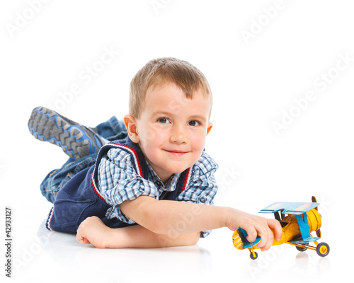 Cute little boy playing with a toy airplane