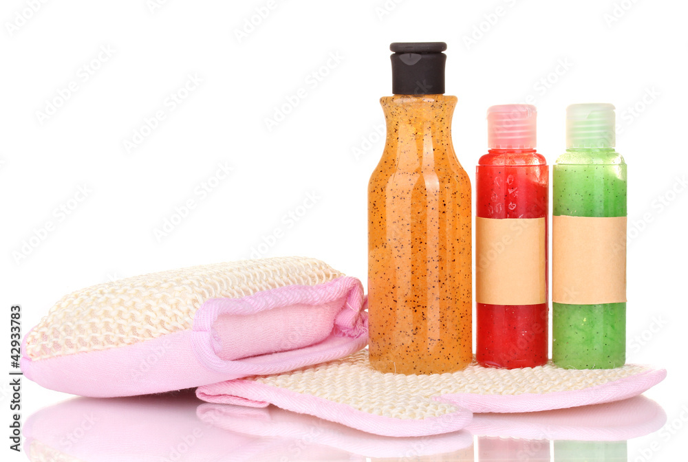 Bottles with scrub and sponges isolated on white Bottles with scrub and sponges isolated on white