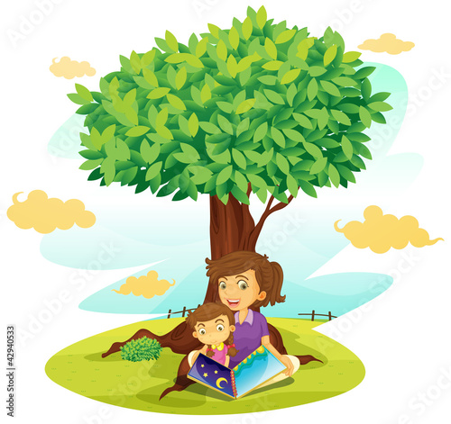 a boy and girl studying under tree