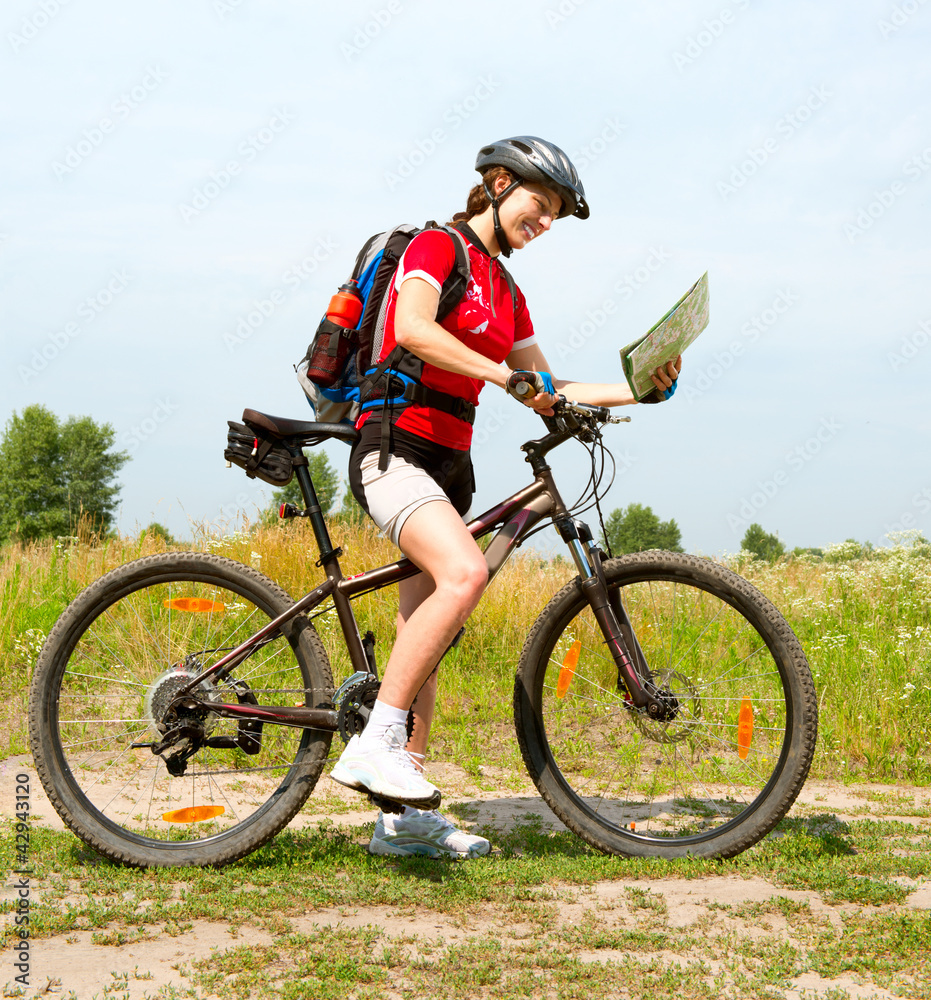 Fototapeta premium Happy Young Woman riding bicycle outside. Healthy Lifestyle