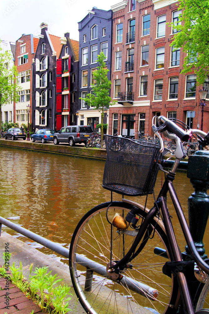 Fototapeta premium Bicycle along the canals of Amsterdam, The Netherlands