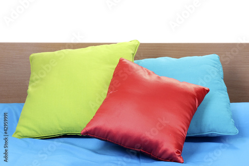 bright pillows on bed on white background