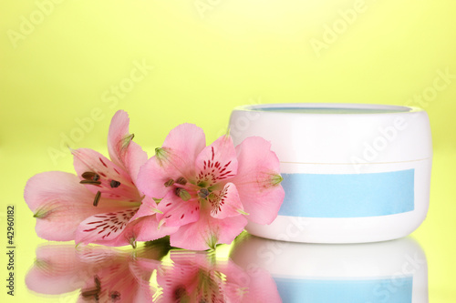 Wallpaper Mural Jar of cream with flower on green background Torontodigital.ca