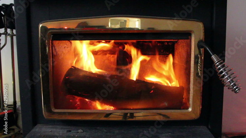 Wood stove with fire burning for heat.