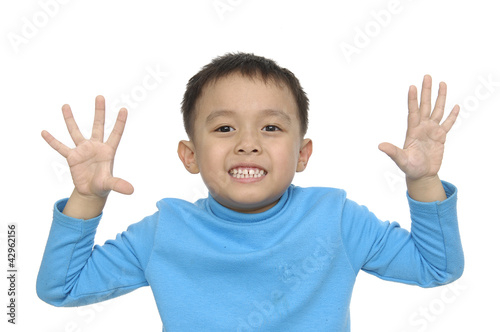 Thumbs up shown by a happy little asian boy