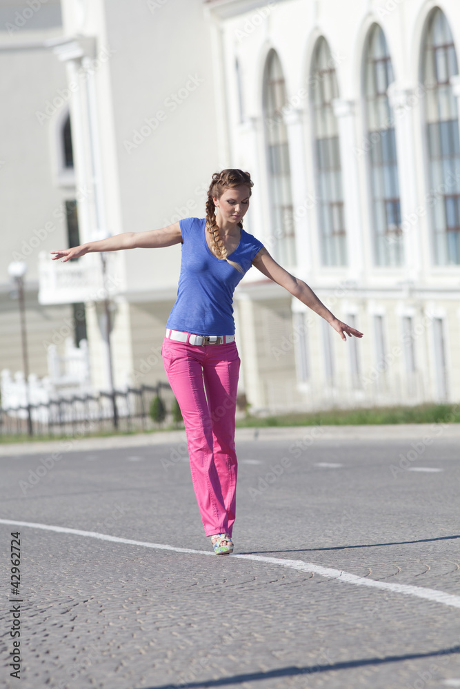 Girl walking along the carriageway