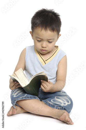 little boy reading a book