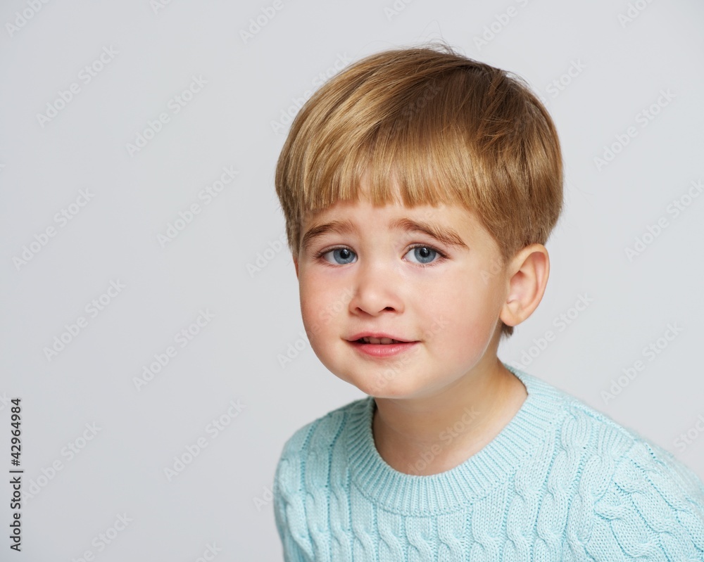 Funny baby boy in blue pullover portrait