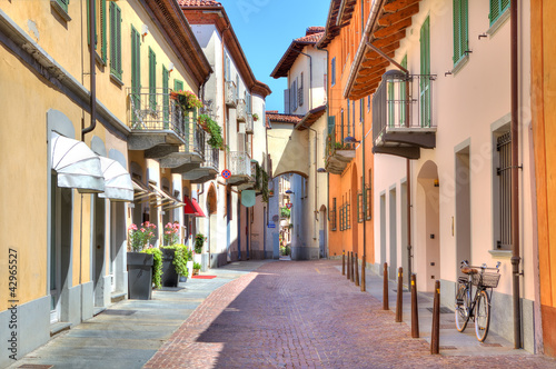 Old colorful street in Alba, Northern Italy.