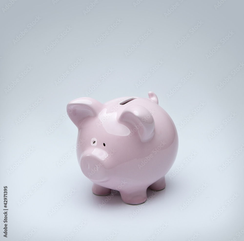 Piggy bank over gray background with copy space Piggy bank over gray background with copy space