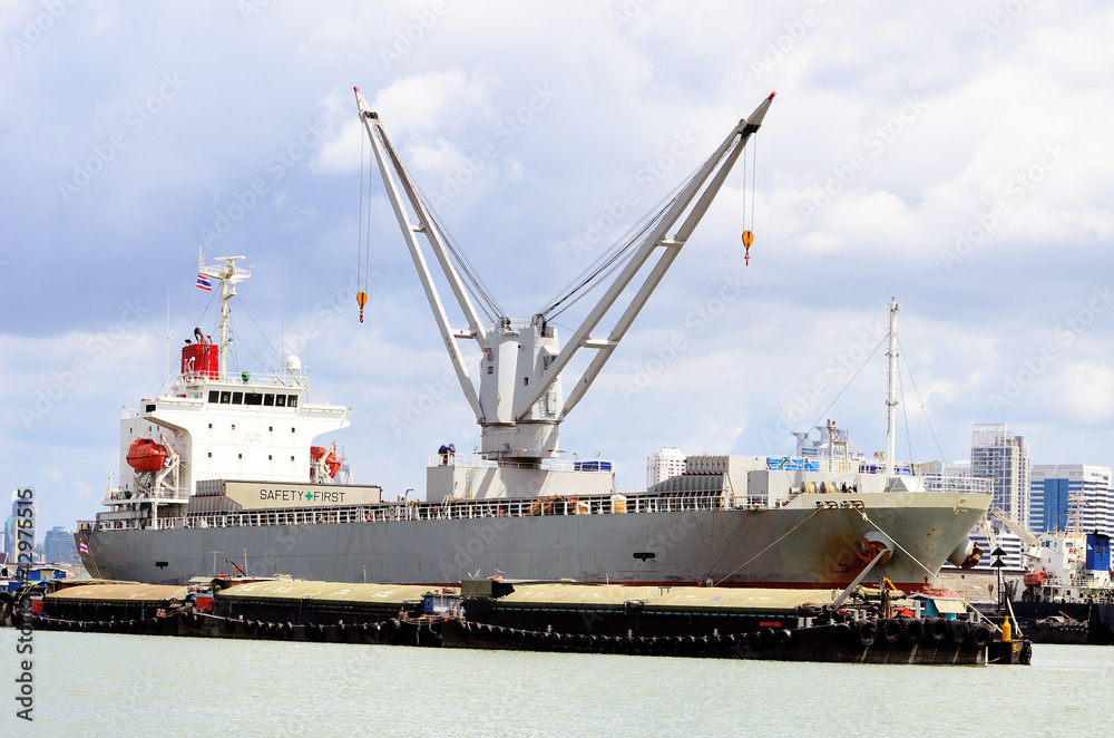 Vessel bulk cargo with crane and lighter in the river Vessel bulk cargo with crane and lighter in the river