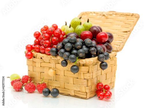 Berries in a wicker basket on a white background