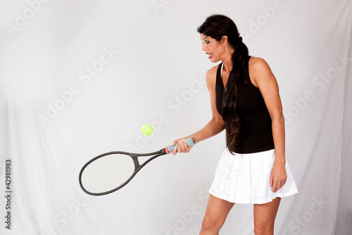 woman in tennis outfit, playing with racket © Allen Penton