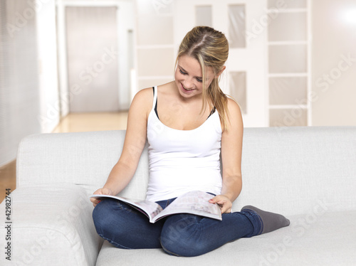 Young woman reading magazine