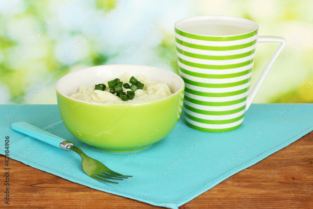 Mashed potato in the bowl and cup with milk Mashed potato in the bowl and cup with milk