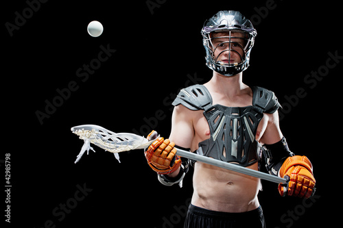 Boys lacrosse player catching a ball