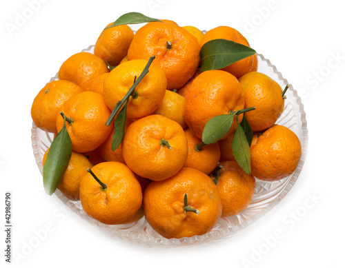 oranges with leaves on a plate