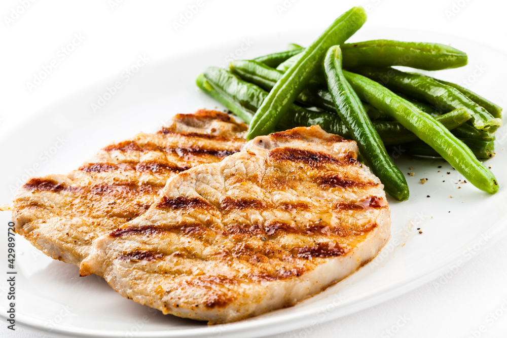 Grilled steaks, baked potatoes and vegetables