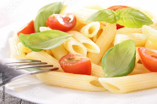 plate of pasta with tomato and basil