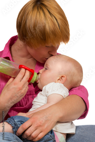 Young Mum bottlefeeding her 10 month old baby photo