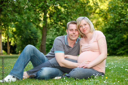 Pregnant couple in the park