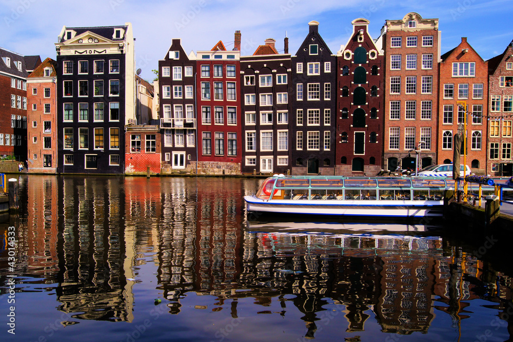 Fototapeta premium Traditional houses of Amsterdam with canal reflections