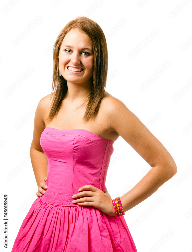 Portrait of happy smiling teenage girl in pink dress