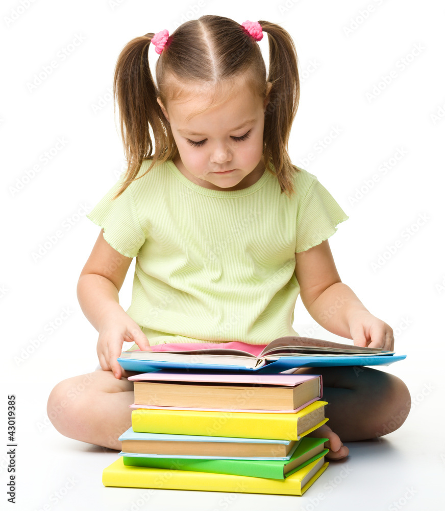 Cute little girl reads a book Cute little girl reads a book