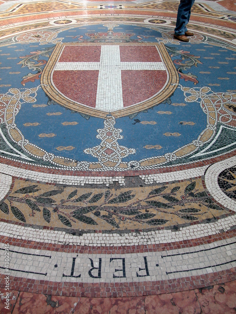 Walking on mosaic in Galleria Vittorio Emanuele II, Milan, Italy