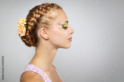 Woman with beautiful hairstyle and creative make-up