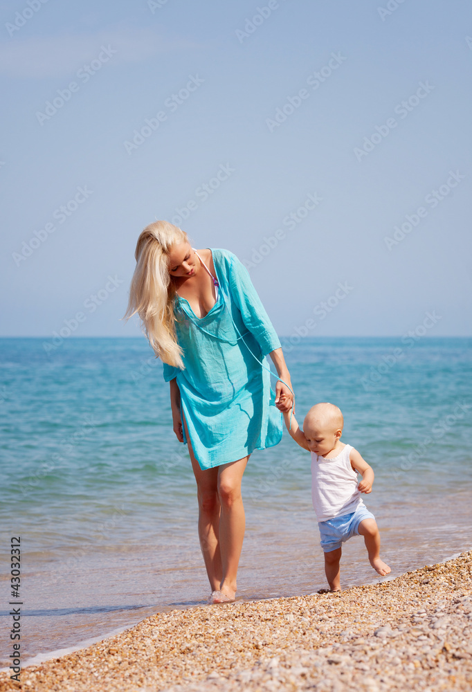 Mother with her baby on the beach Mother with her baby on the beach
