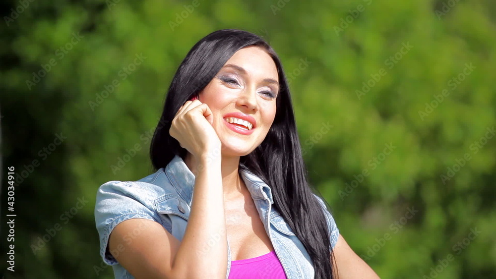 Pretty young female having a conversation over the mobile Pretty young female having a conversation over the mobile