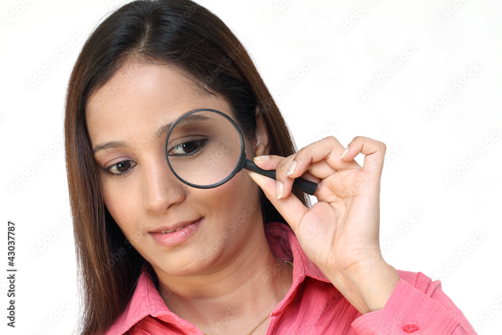 Young woman with magnifier