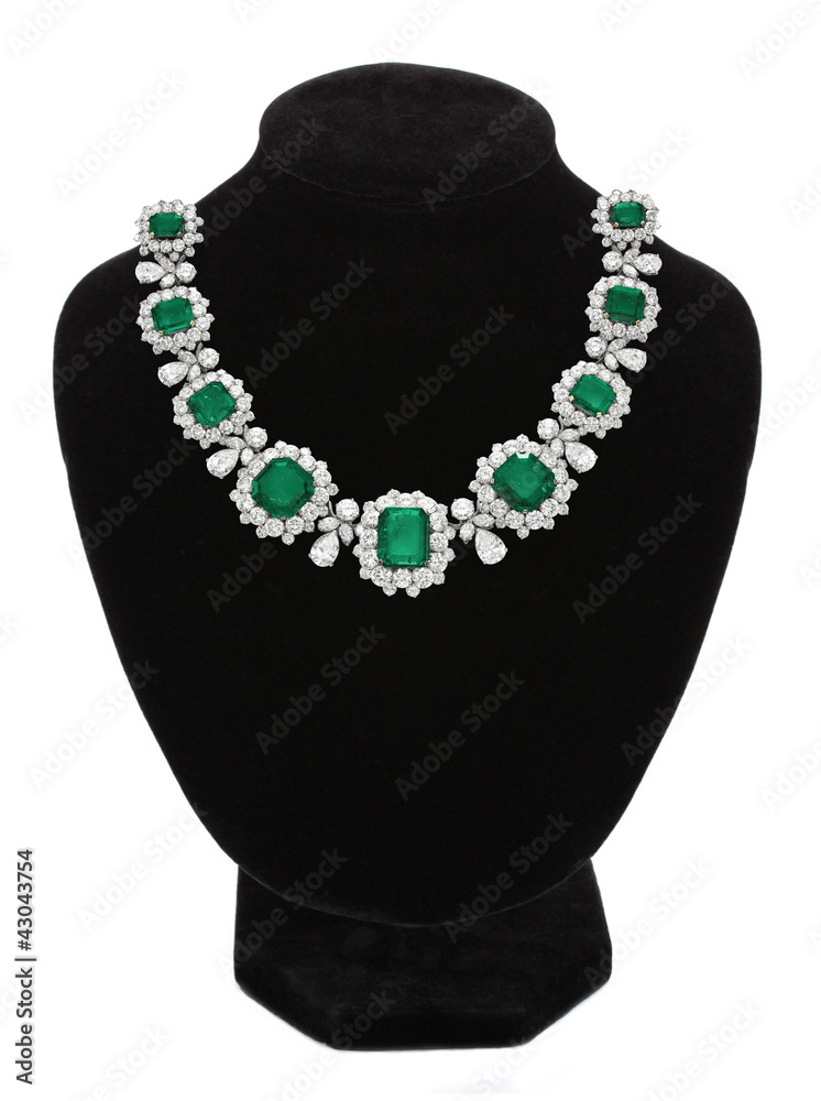 Pendant with green gem stones on black mannequin isolated on whi Pendant with green gem stones on black mannequin isolated on whi