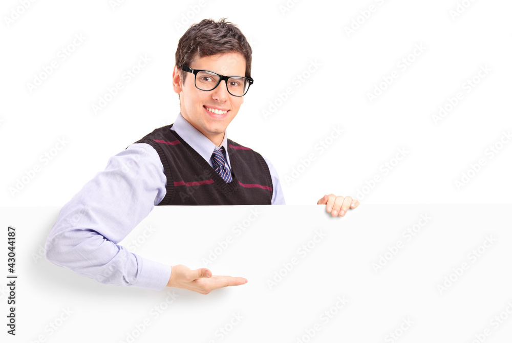 A smiling handsome guy gesturing on a white panel A smiling handsome guy gesturing on a white panel