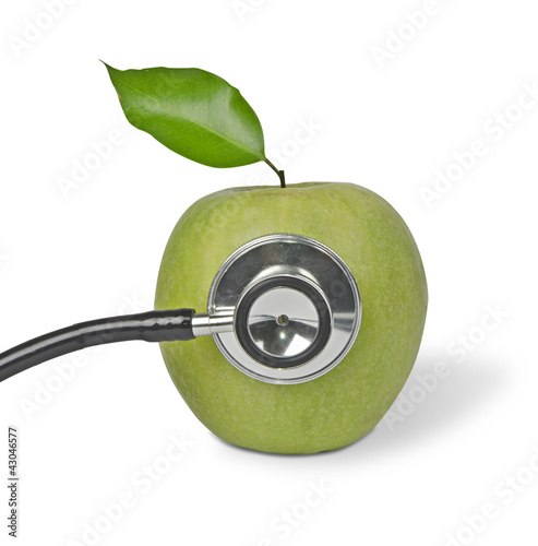 Green apple with stethoscope photo