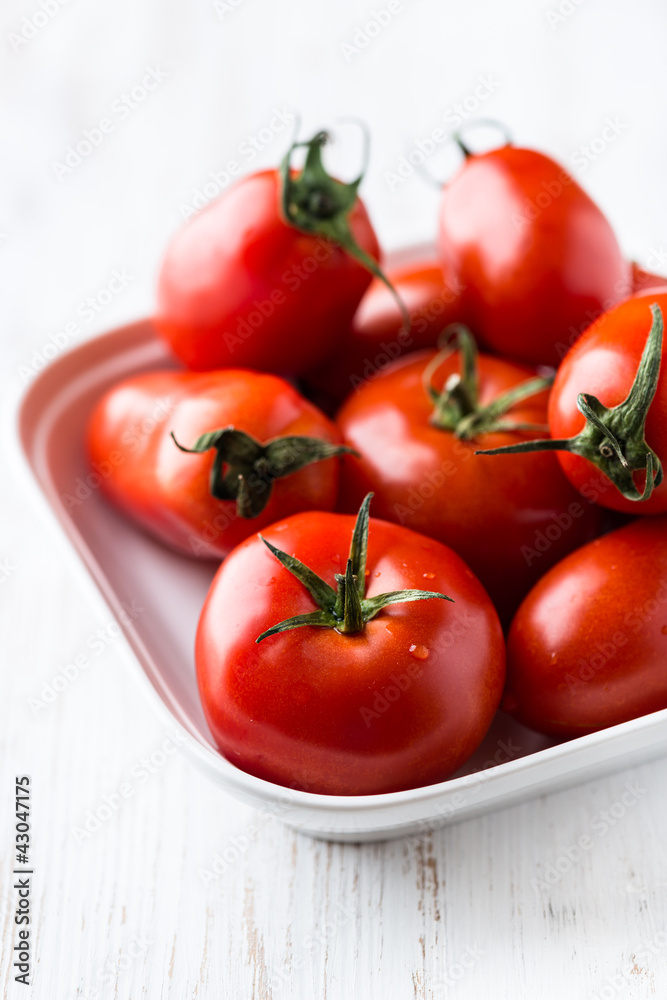 Various red tomatoes in a bowl Various red tomatoes in a bowl