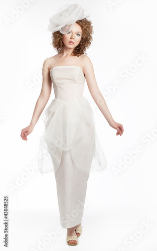 Happy beautiful bride in white dress and hat posing. Studio shot © gromovataya