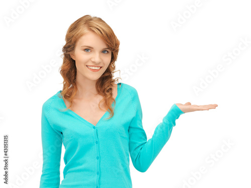 girl showing something on the palm of her hand