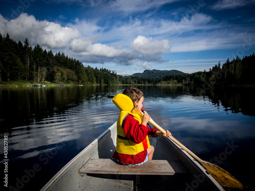 Child canoeing on lake