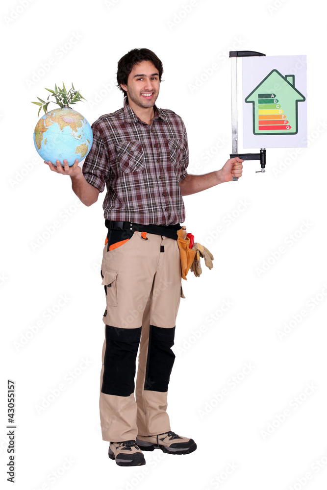 Fototapeta premium Man holding a globe and a sign for energy consumption