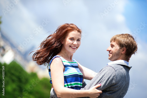Happy positive romantic loving couple is hugging