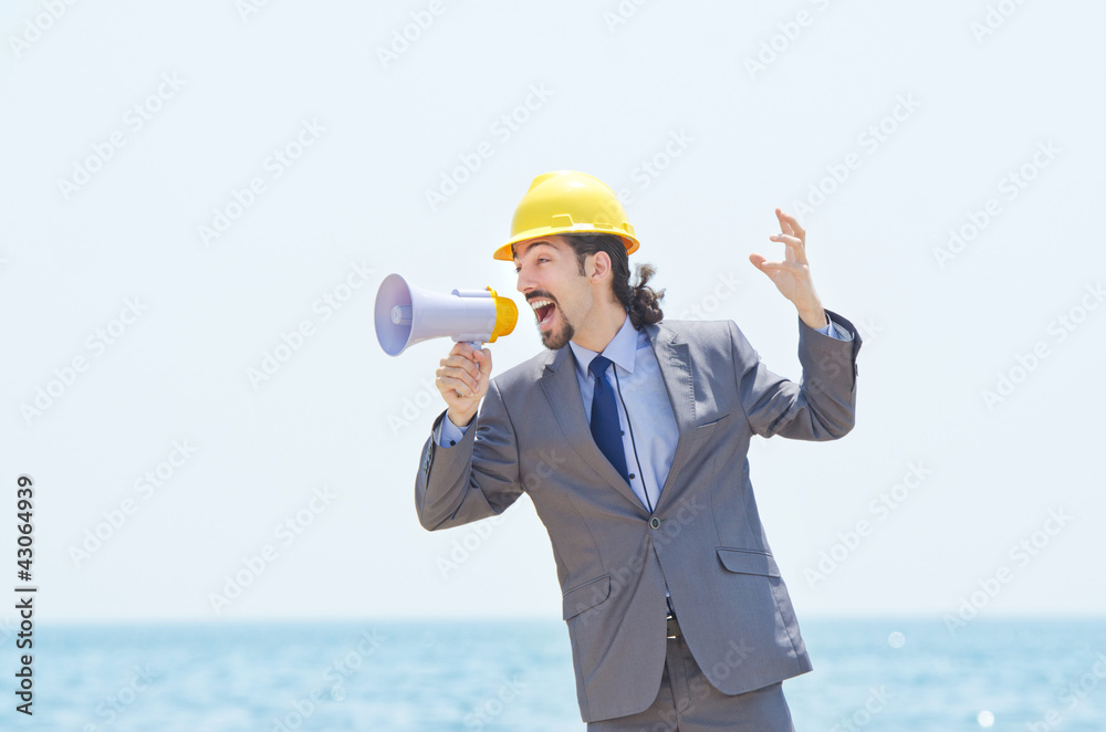 Man wearing helmet speaks with megaphone Man wearing helmet speaks with megaphone
