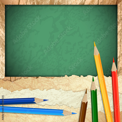 paper pieces with pencils over blackboard