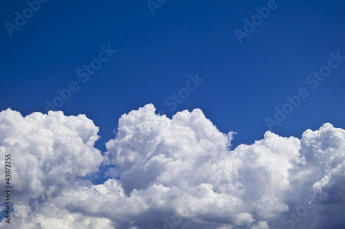 white fluffy clouds over blue sky landscape
