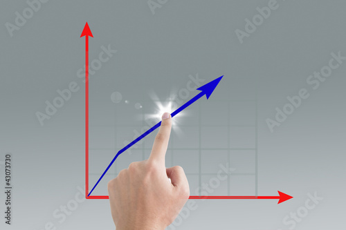 Business man pointing a growing graph on the screen background